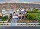 Captivating aerial shot of a desert home, landscaped front yard, and mountain views at 1337 E Paseo Way, Phoenix, AZ 85042