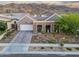 Attractive single-Gathering home featuring desert landscaping, a paved driveway, and a welcoming two-car garage at 1337 E Paseo Way, Phoenix, AZ 85042