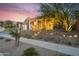 Attractive home exterior with desert landscaping, stone accents, and ample street view under colorful skies at 1337 E Paseo Way, Phoenix, AZ 85042