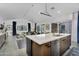 Modern kitchen with a large island that opens to a dining area with sleek chairs and patio views at 1337 E Paseo Way, Phoenix, AZ 85042