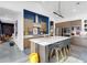Stylish kitchen with wood cabinets, stainless steel appliances, a white countertop island, and a blue accent wall at 1337 E Paseo Way, Phoenix, AZ 85042