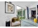 Cozy living room nook with modern art, comfortable chair, and sliding glass doors offering a serene view of the outdoor space at 1337 E Paseo Way, Phoenix, AZ 85042