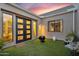 Modern outdoor patio with artificial grass, modern decor, and stylish modern door and windows at 1337 E Paseo Way, Phoenix, AZ 85042
