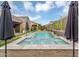 Beautiful backyard pool and spa area featuring lush landscaping and ample seating for entertaining at 1337 E Paseo Way, Phoenix, AZ 85042