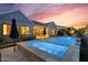 Backyard oasis featuring a pool, hot tub, and outdoor seating, perfect for relaxation and entertaining under the sunset at 1337 E Paseo Way, Phoenix, AZ 85042