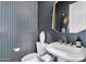 Chic powder room with a unique vessel sink, decorative mirror, and elegant grey walls for a sophisticated touch at 1337 E Paseo Way, Phoenix, AZ 85042