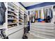 Organized walk-in closet with custom shelving, drawers, and blue accent wall at 1337 E Paseo Way, Phoenix, AZ 85042