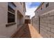 View of the side yard with a concrete block fence and a wooden gate at 15599 S 180Th Ln, Goodyear, AZ 85338