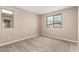 Empty bedroom features neutral tones, plush carpeting, and dual windows for natural light at 15599 S 180Th Ln, Goodyear, AZ 85338