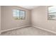Bedroom featuring neutral carpeting, and natural light from dual windows at 15599 S 180Th Ln, Goodyear, AZ 85338