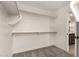Walk-in closet features multiple shelves, wooden rails, and carpeted flooring at 15599 S 180Th Ln, Goodyear, AZ 85338