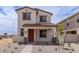 Charming two-story home featuring a tile roof, front porch, and low-maintenance desert landscaping at 15599 S 180Th Ln, Goodyear, AZ 85338