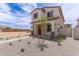 Two-story home featuring a covered front porch and desert landscaping, set in a developing neighborhood at 15599 S 180Th Ln, Goodyear, AZ 85338