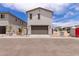 Two-story single Gathering home boasts a neutral color, attached garage, and low maintenance desert landscaping at 15599 S 180Th Ln, Goodyear, AZ 85338
