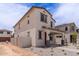 Two-story home with a covered porch and desert landscaping, nestled within a developing community at 15599 S 180Th Ln, Goodyear, AZ 85338