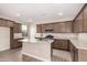Modern kitchen with island, granite countertops, stainless steel appliances, and abundant cabinetry at 15599 S 180Th Ln, Goodyear, AZ 85338