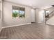 Spacious living area with wood-look tile flooring, large windows, and neutral paint at 15599 S 180Th Ln, Goodyear, AZ 85338