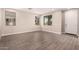 Bright, open living space featuring wood-look tile, neutral paint, and ample natural light at 15599 S 180Th Ln, Goodyear, AZ 85338