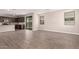 Open-concept living space with wood-look tile flooring and views into the kitchen at 15599 S 180Th Ln, Goodyear, AZ 85338