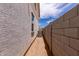 View of a side yard with an air conditioning unit and concrete block fence at 15599 S 180Th Ln, Goodyear, AZ 85338