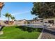 This backyard features a swimming pool, lush green grass, and is great for relaxing at 156 E Jasmine St, Mesa, AZ 85201