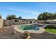 Backyard features a private pool and a well manicured yard with mature trees at 156 E Jasmine St, Mesa, AZ 85201