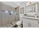 Bathroom features modern tile shower, brushed brass fixtures and a stylish vanity at 156 E Jasmine St, Mesa, AZ 85201