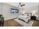 Bedroom features neutral decor, ceiling fan and large window for natural light at 156 E Jasmine St, Mesa, AZ 85201