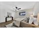 Brightly lit bedroom with ceiling fan, light color walls and wood-look floors at 156 E Jasmine St, Mesa, AZ 85201