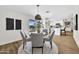 Open dining area featuring modern furnishings and lighting adjacent to the bright kitchen at 156 E Jasmine St, Mesa, AZ 85201