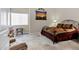Cozy bedroom with a metal-framed bed, warm-toned bedding, and a window with blinds at 16357 E Arrow Dr # 115, Fountain Hills, AZ 85268