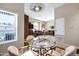 Open dining area with chandelier, living room view, and abundant natural light at 16357 E Arrow Dr # 115, Fountain Hills, AZ 85268