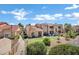 Well-maintained condo exterior with tile roof, desert landscaping, and mini-golf putting green at 16357 E Arrow Dr # 115, Fountain Hills, AZ 85268
