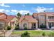 Well-maintained condo exterior with tile roof, desert landscaping, and mini-golf putting green at 16357 E Arrow Dr # 115, Fountain Hills, AZ 85268