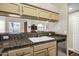 Bright kitchen view showcasing granite countertops, and a view through to living room at 16357 E Arrow Dr # 115, Fountain Hills, AZ 85268