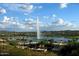 Picturesque fountain surrounded by trees and buildings, with a backdrop of rolling hills and a blue sky at 16357 E Arrow Dr # 115, Fountain Hills, AZ 85268