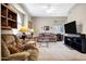 Comfortable living room featuring neutral colors, ceiling fan, and large entertainment center at 16357 E Arrow Dr # 115, Fountain Hills, AZ 85268