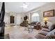 Spacious living room with ceiling fan, glass coffee table, and view of front entry at 16357 E Arrow Dr # 115, Fountain Hills, AZ 85268