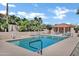 Community pool area with lush palm trees, lounge chairs, and a covered pavilion at 16357 E Arrow Dr # 115, Fountain Hills, AZ 85268