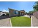 Backyard features a lovely patio and artificial grass area, offering low-maintenance outdoor living at 16930 W Woodlands Ave, Goodyear, AZ 85338