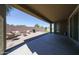 Backyard features a covered patio, outdoor seating, and a grill with desert landscaping at 16930 W Woodlands Ave, Goodyear, AZ 85338