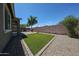 Well-maintained backyard with artificial turf and patio area is perfect for relaxing and entertaining at 16930 W Woodlands Ave, Goodyear, AZ 85338