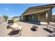 Outdoor patio area with grill and comfortable seating, ideal for enjoying the beautiful weather at 16930 W Woodlands Ave, Goodyear, AZ 85338