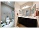 This bathroom has a double sink vanity with framed mirrors and a toilet at 16930 W Woodlands Ave, Goodyear, AZ 85338