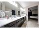 This bathroom has a double sink vanity with framed mirrors at 16930 W Woodlands Ave, Goodyear, AZ 85338
