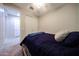 A small bedroom is furnished with a plush bed, closet, and neutral walls at 16930 W Woodlands Ave, Goodyear, AZ 85338