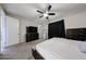 This spacious bedroom has a ceiling fan, flatscreen television, and a large dresser at 16930 W Woodlands Ave, Goodyear, AZ 85338