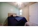 Cozy bedroom features neutral tones and a window, offering a serene retreat at 16930 W Woodlands Ave, Goodyear, AZ 85338