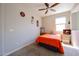 Cozy bedroom with bright walls, window, and ceiling fan at 16930 W Woodlands Ave, Goodyear, AZ 85338