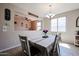 Cozy dining room with a table set for four and an open view to the adjacent living room at 16930 W Woodlands Ave, Goodyear, AZ 85338